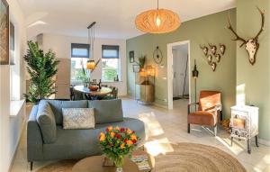 a living room with a couch and a table at Nice Home In Putten With Kitchen in Putten