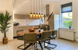 a kitchen with a wooden table and chairs in a kitchen at Nice Home In Putten With Kitchen in Putten