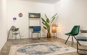 a room with chairs and a table and a rug at Nice Home In Putten With Kitchen in Putten +27 photos