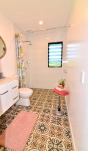 a bathroom with a toilet and a sink at Studio with Rural views in Goonellabah