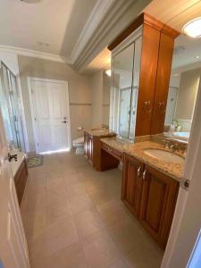 a large bathroom with two sinks and a large mirror at Lucky suite, two-bedroom suite in Richmond close to YVR in Richmond