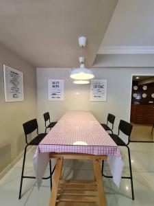 a table with a pink and white table cloth on it at MG Mutiara Gurney in George Town