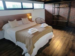 a bedroom with a large bed with towels on it at Terrazas del Monte in San Miguel del Monte +23 photos