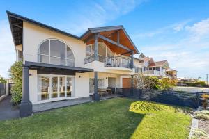 an image of a house with a yard at Beachfront Family Favourite Home with Pool & Views in Mandurah