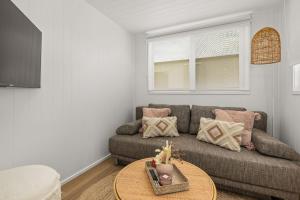 sala de estar con sofá y mesa en Husky Tiny Home by Experience Jervis Bay en Huskisson
