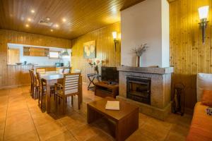 a living room with a table and a fireplace at Casa das Arribas - Rio Douro aos seus pés in Bemposta