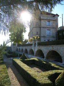a building with a bridge in front of a building at Château du Grand Jardin in Valensole