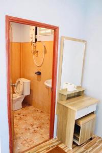 a bathroom with a toilet and a mirror at Sai Klong Song Lae Resort Pakpra Phatthalung in Phatthalung