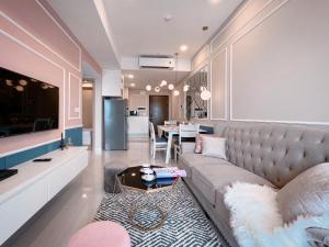 a living room with a couch and a table at Tommy Homes in Soho Residence Central District 1 in Ho Chi Minh City