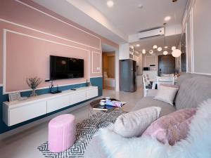 a living room with a couch and a flat screen tv at Tommy Homes in Soho Residence Central District 1 in Ho Chi Minh City