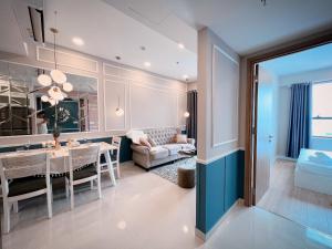 a kitchen and dining room with a dining table and a couch at Tommy Homes in Soho Residence Central District 1 in Ho Chi Minh City
