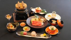 a table with plates of food on a table at Minakamisansou in Minakami