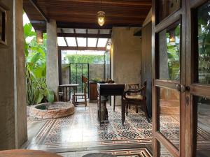 a room with a table and chairs and a patio at Chiang Maan Residence in Chiang Mai