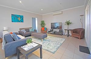 a living room with a couch and a tv at Boronia 4x2 in Jurien Bay