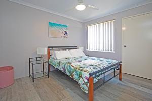 a bedroom with a bed and a window at Boronia 4x2 in Jurien Bay