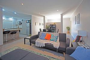 a living room with a couch and a kitchen at Boronia 4x2 in Jurien Bay