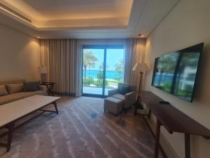 a living room with a couch and a view of the ocean at Luxury sea view Apartment In Address Hotel Fujairah in Fujairah