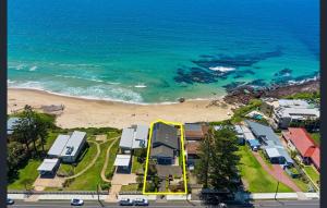 an aerial view of a beach with houses and the ocean at Sea View - Absolute Beachfront Shellharbour in Shellharbour