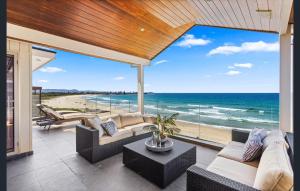a living room with a view of the ocean at Sea View - Absolute Beachfront Shellharbour in Shellharbour
