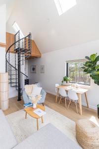 a living room with a spiral staircase and a table at Lakeside South at Live Oak Lake in Bellmead