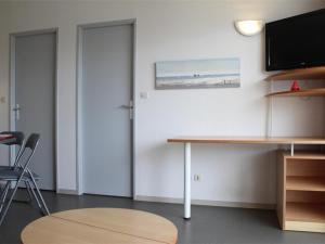 um quarto com uma mesa e uma televisão na parede em Appartement La Rochelle, 2 pièces, 4 personnes - FR-1-246-177 em La Rochelle
