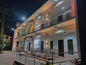 a large white building with a balcony at night at Ohana Hometel in Sorsogon