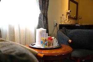 a room with a table with a candle on it at Constantia Manor Guest House in Pretoria