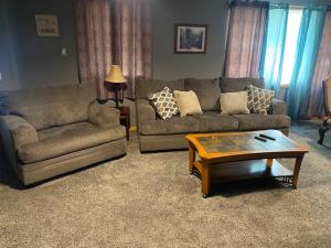 a living room with two couches and a coffee table at Lodge 545 Complete Large brick house fully furnished in Agra