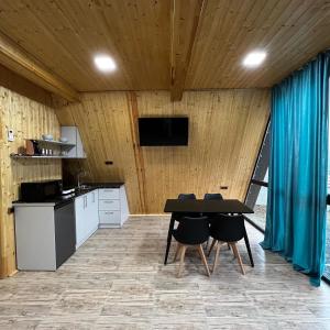 a kitchen with a table and chairs in a room at Green Villa Resort Light Blue in Dilijan