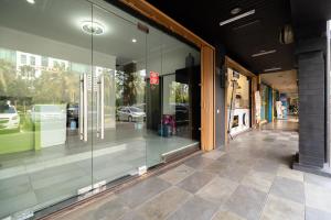 a store front with glass windows on a street at Urbanview Hotel Bizhome Artha Gading Boulevard by RedDoorz in Jakarta