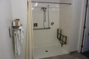 y baño con ducha y puerta de cristal. en Budget Inn Redwood City, en Redwood City