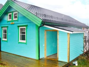 a blue house with a black roof at 6 person holiday home in M L Y in Måløy