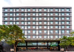 a large brick building with windows at Holiday Inn Express Taiyuan High Tech Zone, an IHG Hotel in Taiyuan