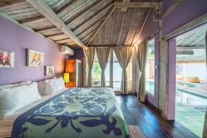 a bedroom with a bed and a swimming pool at Villa West - Charming 2 bdr villa in Oberoi - PERFECT LOCATION! in Seminyak