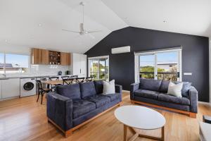 a living room with a couch and a table at Island Getaway Cape Woolamai in Cape Woolamai