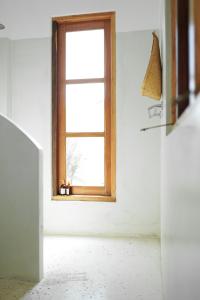 a window in a room with a white wall at The Oasis Villa in Ahangama