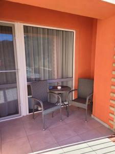 a patio with a table and chairs on a balcony at Sinaia Belleview in Sinaia