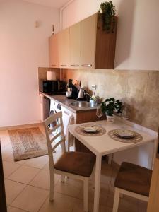 a kitchen with a table and chairs and a sink at Sinaia Belleview in Sinaia