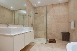 巴利托9 On Crystal Cove 5 Bedroom Townhouse in Zimbali的浴室配有洗手池和玻璃淋浴房 更多22张照片