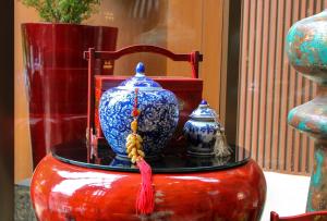 two blue and white vases sitting on top of a table at Ashley Tang Menteng Jakarta in Jakarta