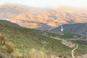 a view of a mountain with a white cross on it at Cortijo La Vista in Órgiva