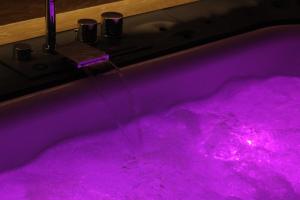 a hot pink bathtub filled with pink water at Le casette in Monopoli