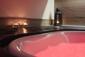 a bathroom with a pink sink and a stove at Le casette in Monopoli