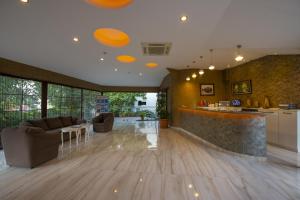 a living room with a bar and a kitchen at Han Deluxe Hotel in Oludeniz