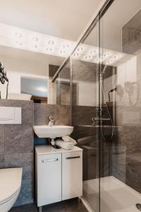 a bathroom with a sink and a shower at Oberwinklgut in Bischofshofen