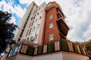 a tall white building with a red brick at Sunshine Boutique Hotel in Kathmandu