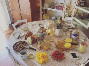 a table with food and drinks on top of it at Penelope B&B in Palermo
