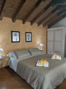 a bedroom with a large bed with two boxes on it at B&B Casa del Teatro in Mantova