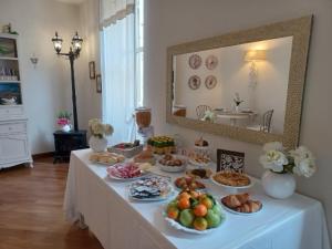 a table with many plates of food on it at B&B Casa del Teatro in Mantova