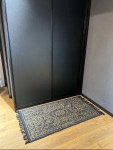 a black door with a rug in front of it at stylish apartment by the SEA in Ashdod
